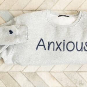 A sweatshirt with the word anxious written on it.