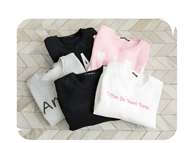 Folded sweatshirts with motivational phrases.